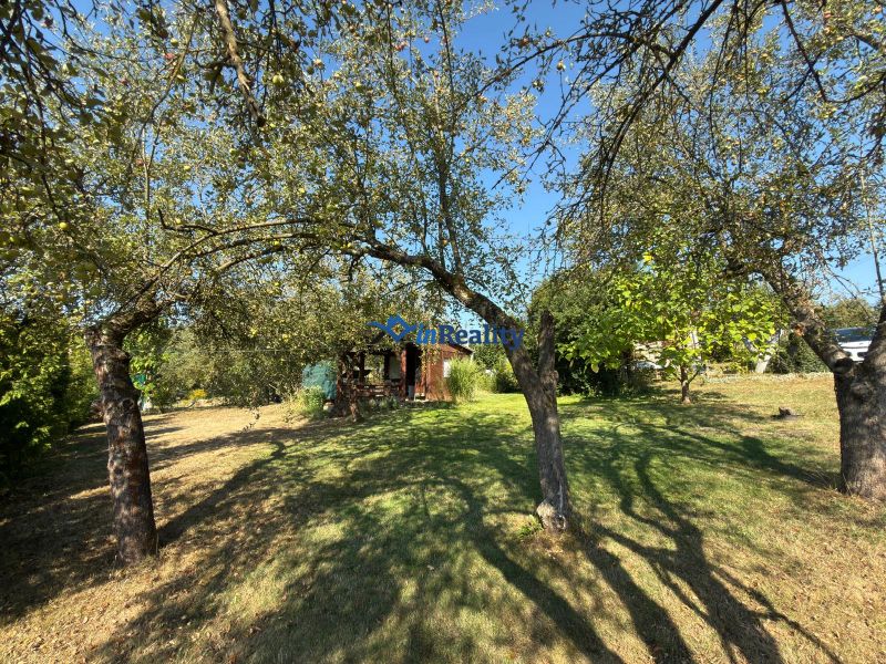 A garden with fruit trees near the cottage on Vinica Street in Lučenec.