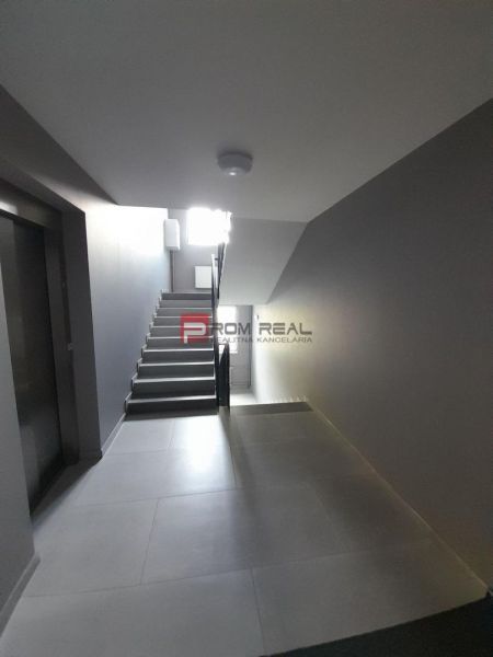 Hallway with stairs and elevator in a 2-room apartment.