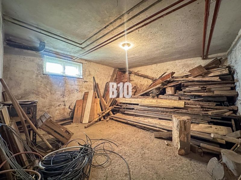 Basement of a family house with stored wood and cables.