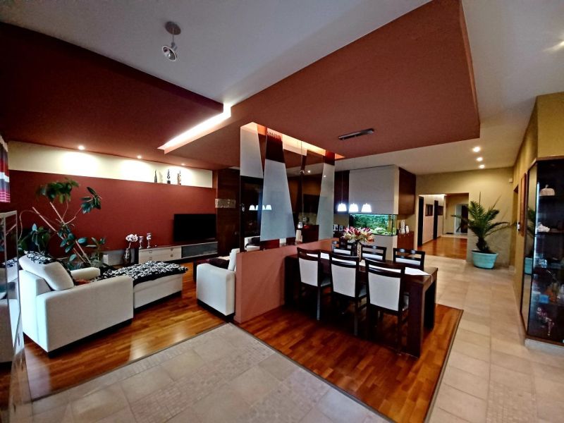 Living room and dining room in a family house with a wooden decor floor.