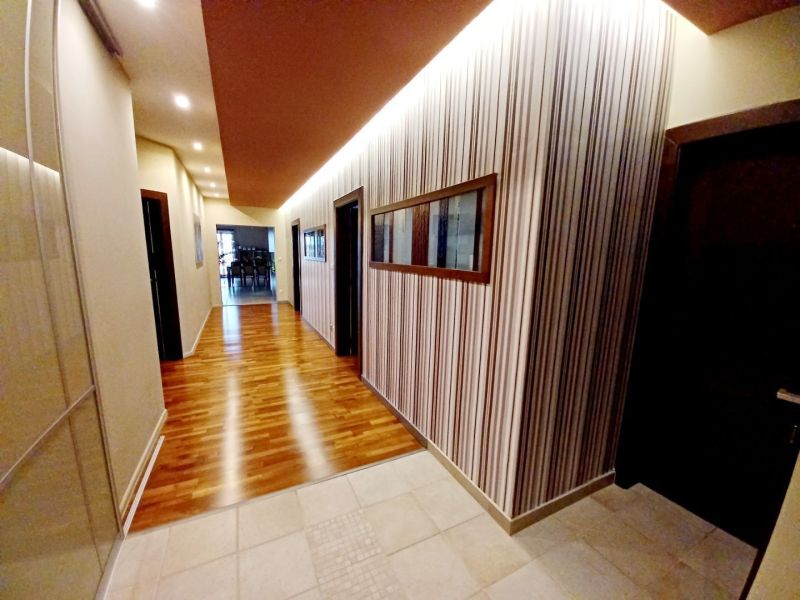 Interior of a family house with a wooden decor floor and striped walls.