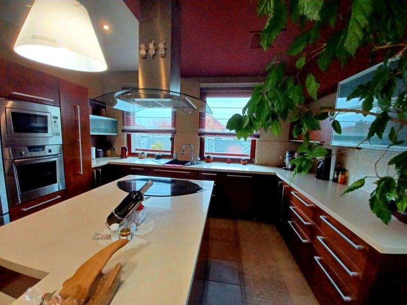 A kitchen in a family house with modern appliances and a central island.