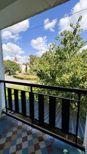 View from the balcony of a family house on Jarná Street in Novosad with a checkered pattern floor.