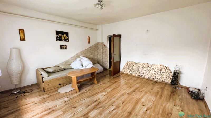 Living room in a family house with a sofa and wooden decor flooring.