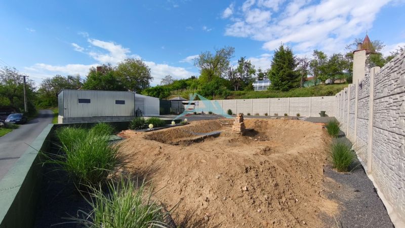 Construction site on Recreational Lands in Záhorce on Selešťany Street with greenery and a building.