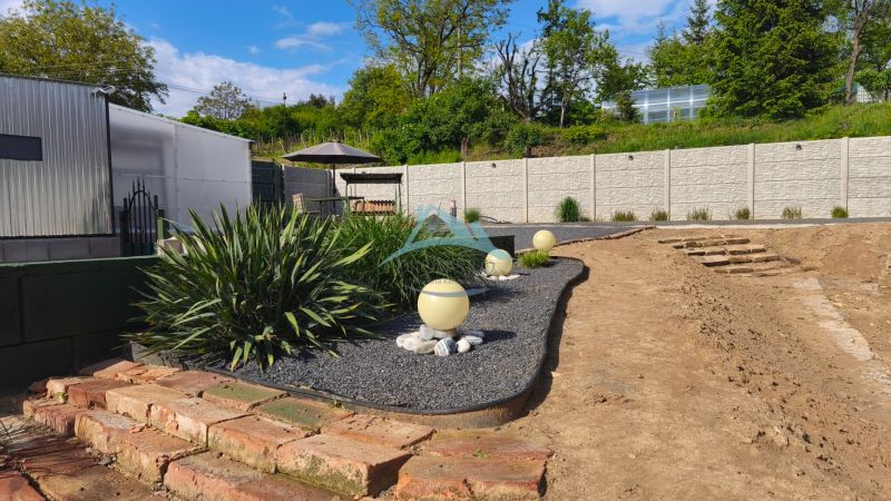 Garden near recreational plots in Záhorce at Selešťany with ornamental plants and flower beds.