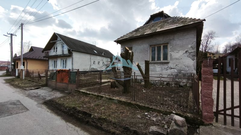 A family house on Tučekova Street in Veľký Krtíš, next to other houses.