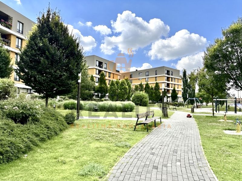 Residential complex with a park and playground on Bajkalská in Bratislava, Ružinov, surrounded by greenery.