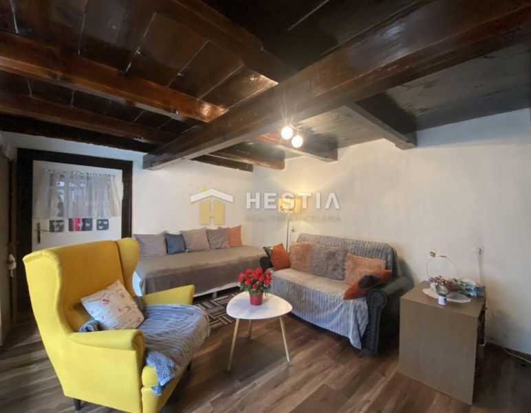 Living room in a family house with a wooden decor floor and comfortable furniture.