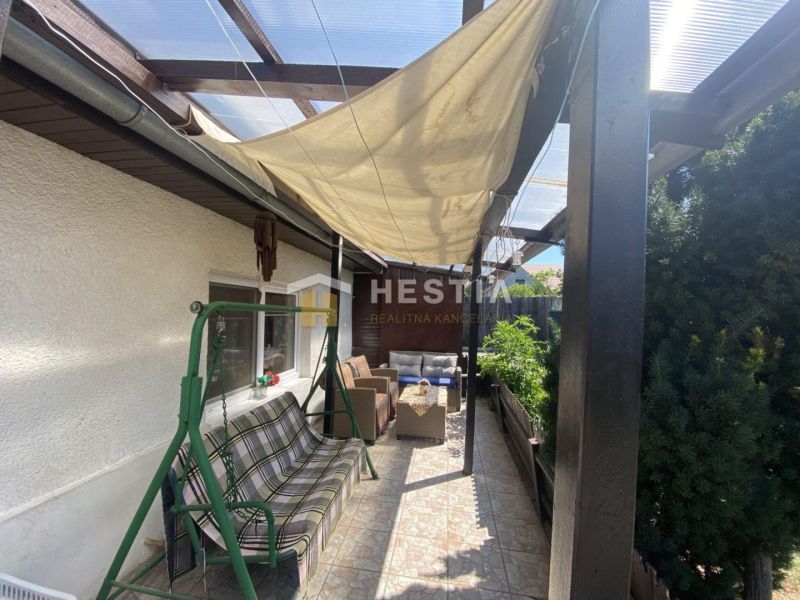 The terrace of a family house in Borský Mikuláš with a shelter and a garden swing.