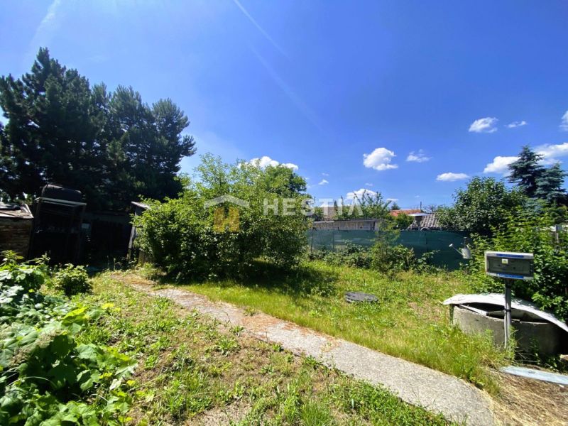 A garden at a family house in Borský Mikuláš with a pathway and surrounding greenery.
