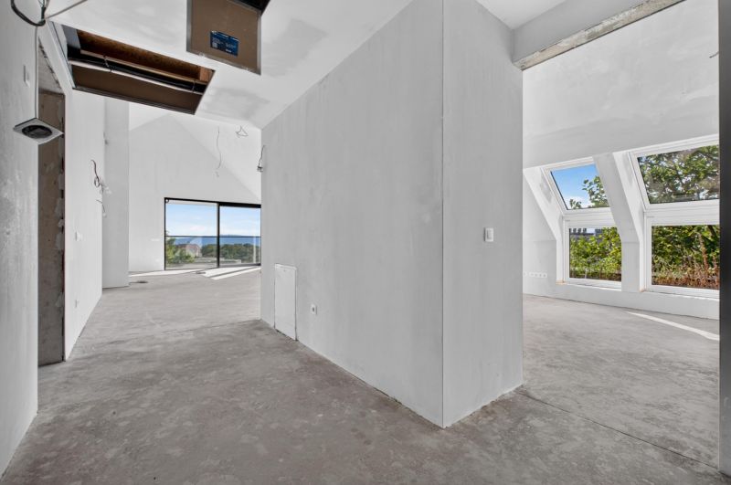 A spacious interior with large windows in a 5 or more room apartment.