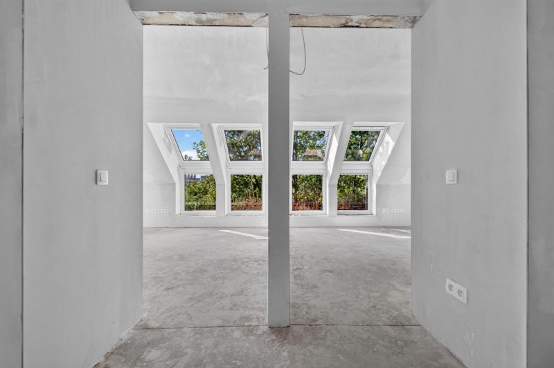A white interior with large skylights in a 5 or more room apartment.