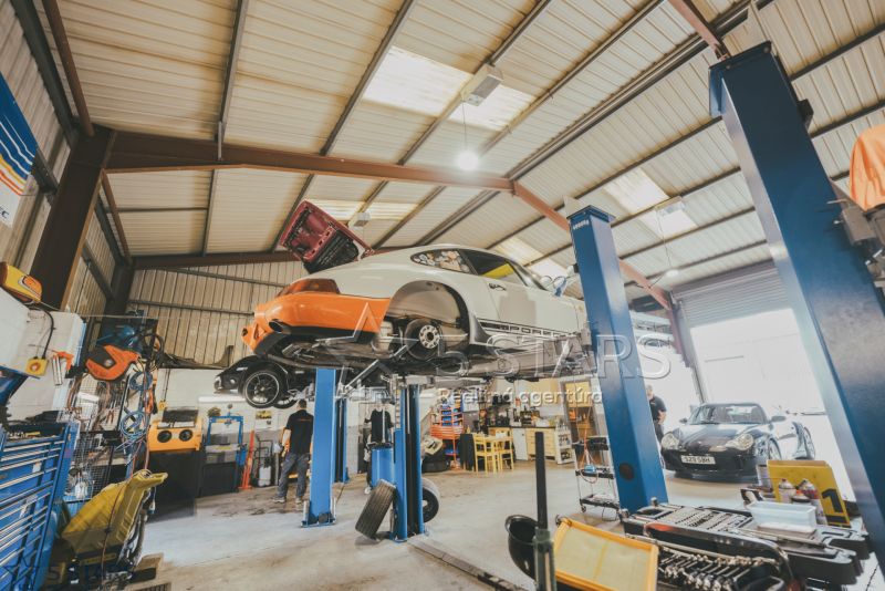 Auto service with two lifts, vehicles, and tools in the space of special properties.