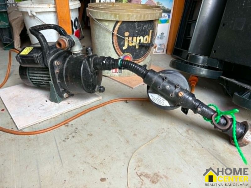 Pump and hose on a floor with a wooden decor in the Gardens.