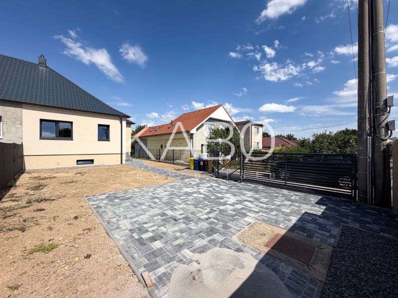 A family house on Trnavská Street in Nitra with a paved courtyard and blue sky.