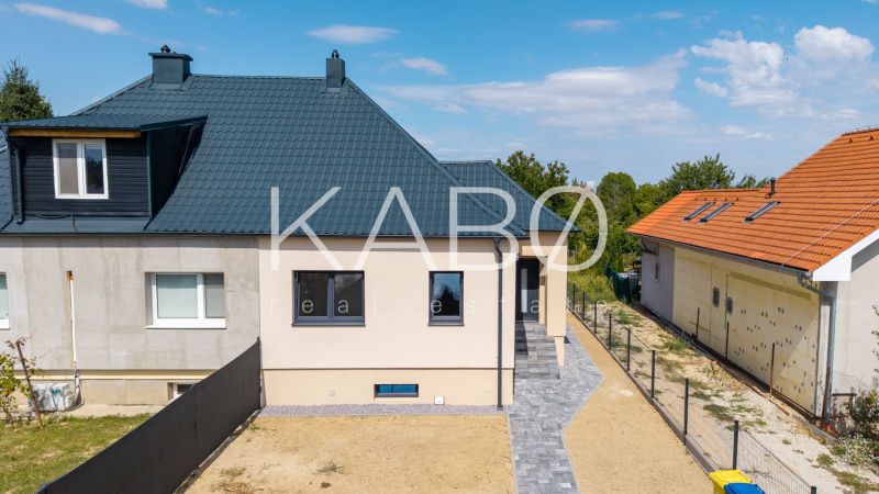 A family house on Trnavská Street in Nitra with a dark roof and a landscaped yard.