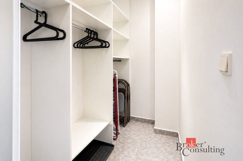 Storage space with hangers in a 2-room apartment and flooring with decor.