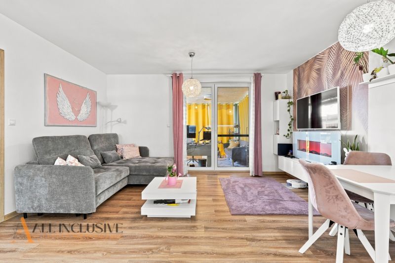 Living room in a family house with a comfortable sofa and a wooden decor floor.