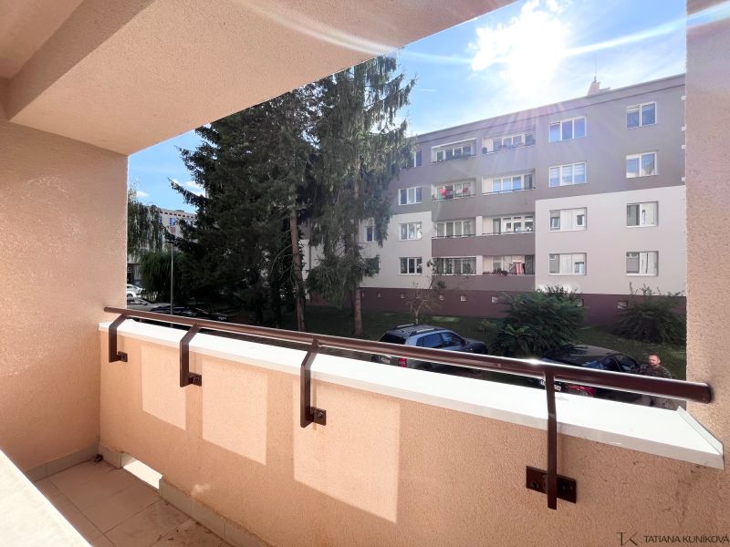 The balcony of a 3-room apartment on Švermova Street, Trenčín with a view of the surrounding building.