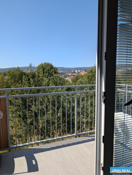 The view from a 2-room apartment in Pezinok on Mahulanka Street includes a balcony and trees.