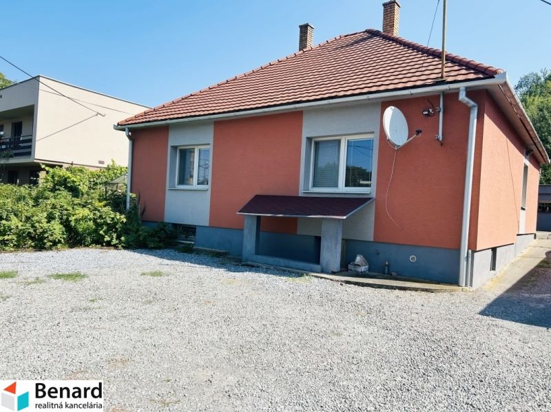 A family house on Sabinovská Street in Prešov, with an orange facade and a gravel yard.