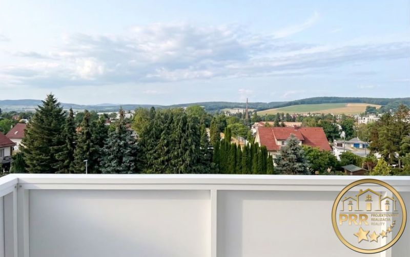 View of greenery and rooftops in Bánovce nad Bebravou from a 2-room apartment.