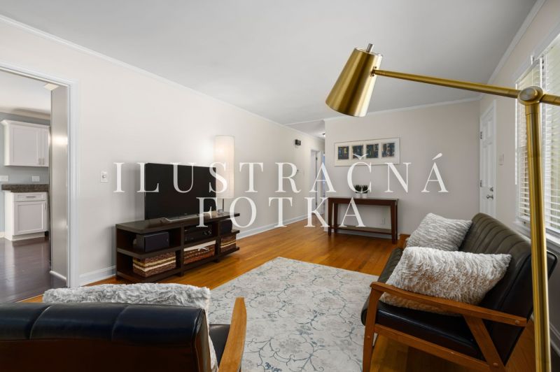 Living room in a 3-room apartment, with a sofa and television, floor with wooden decor.
