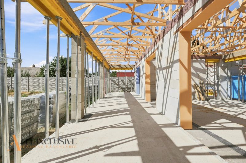 An unfinished family house in Marcelová with exposed roof structures and support columns.