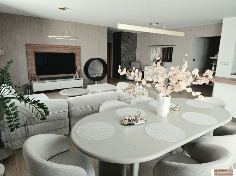 Bright living room in a 4-room apartment with decorative elements and wood-patterned flooring.