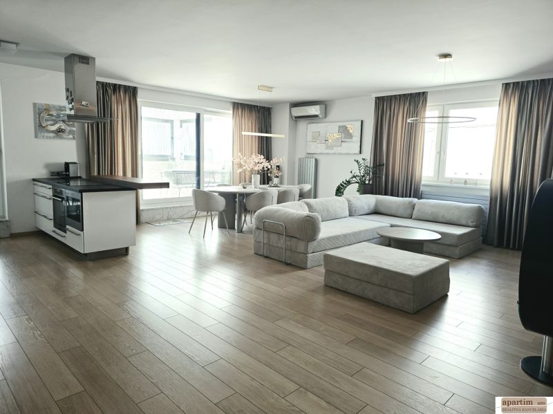 Living room with a kitchenette, wooden decor flooring, spacious sofa, 4-room apartment.