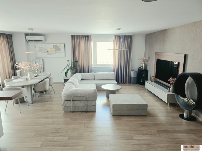 Living room with a light-colored sofa set, wooden decor flooring, dining table, 4-room apartment.