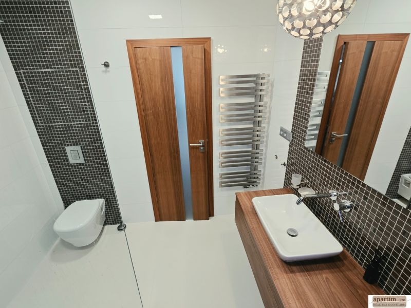 Bathroom with a wall-hung toilet, sink, and radiator in a 4-room apartment.