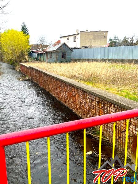 Image from Jarková Street, Košice - Šaca district, with a stream and adjacent lands.
