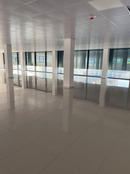 Spacious commercial spaces with large windows and shiny floors.