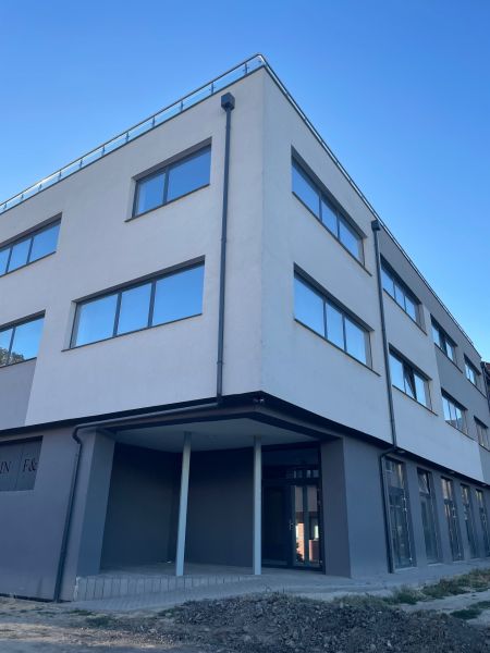 A building with large windows at Komenského 2A 2B in Levice, suitable for commercial spaces.