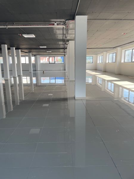Spacious commercial spaces with shiny flooring and plenty of natural light.