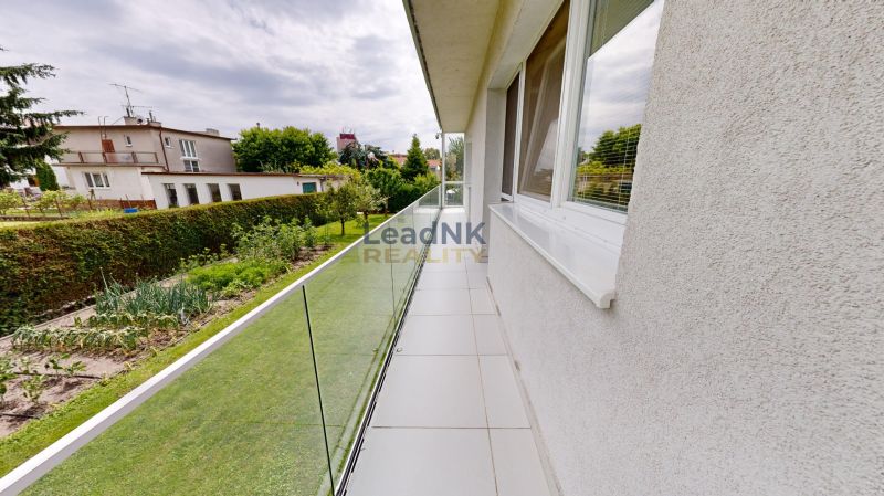 A balcony with glass railings in Petržalka on Kremnická Street, at a three-room apartment.
