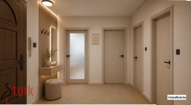 A hallway in a 2-room apartment with a wooden decor floor and cozy lighting.