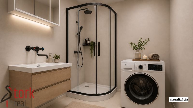 Bathroom in a 2-room apartment with a washing machine, shower, and sink.