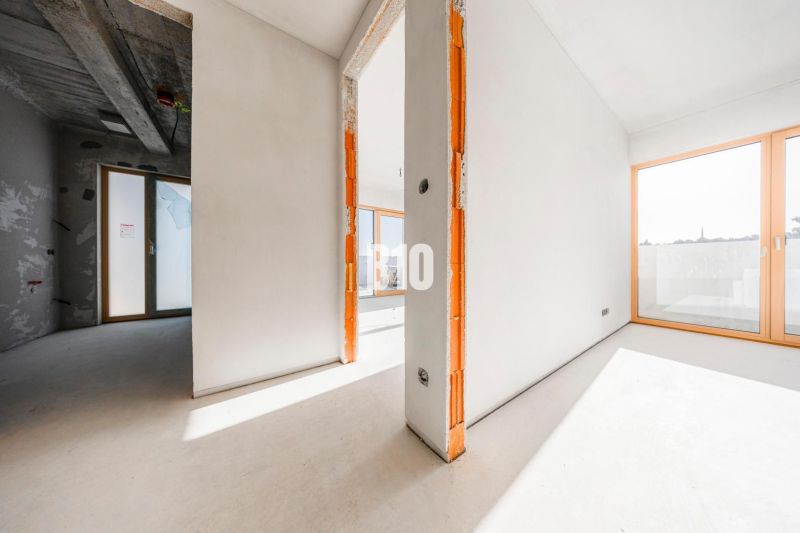 A spacious interior of an unfinished 3-room apartment with large windows and a concrete ceiling.