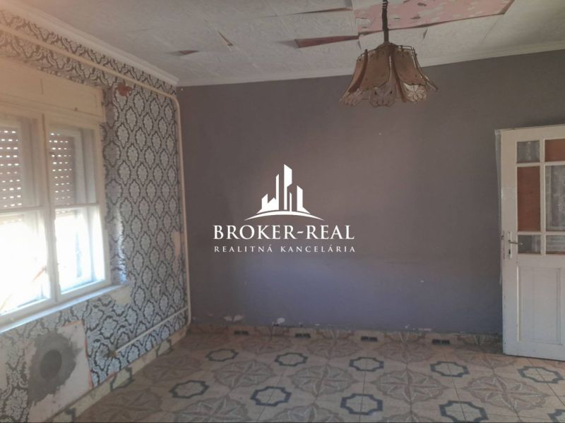 Interior in a family house with decorative wallpapers and ceramic flooring.