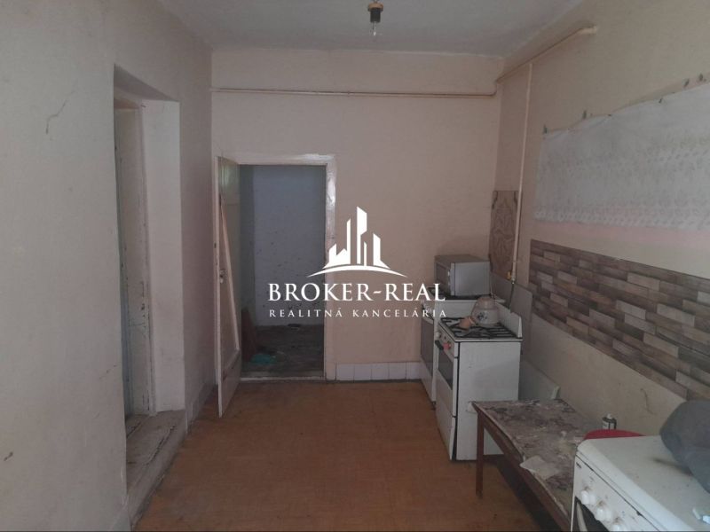 Interior of a family house with a kitchen, gas stove, and tiles.