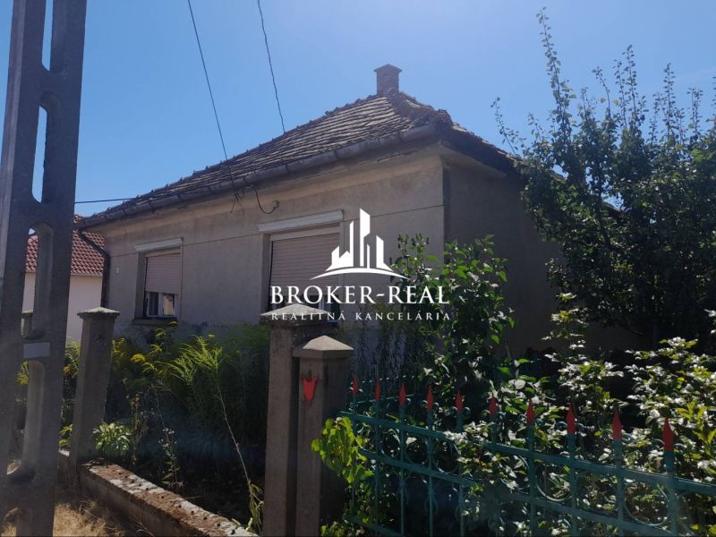 A family house in Csobád with a simple facade and a garden.