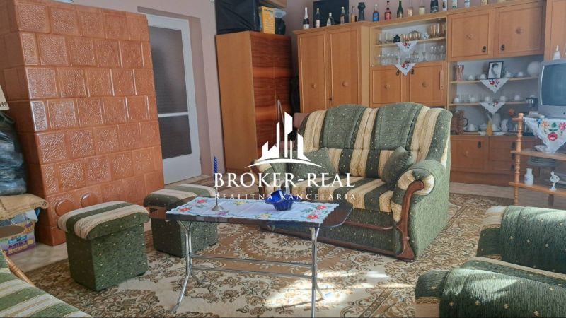 Interior of a family house with carpet decor, fireplace, and traditional furniture.