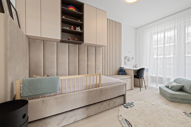 Children's room with a bed, desk, and wooden decor flooring in a 3-room apartment.