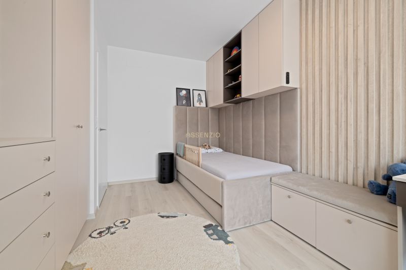 A children's room with storage cabinets and a bed tastefully matches in a three-room apartment.