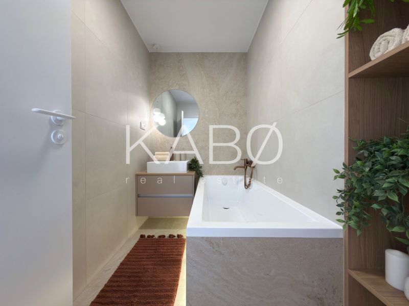 A bathroom with a bathtub and a sink in a 3-room apartment with beige walls.