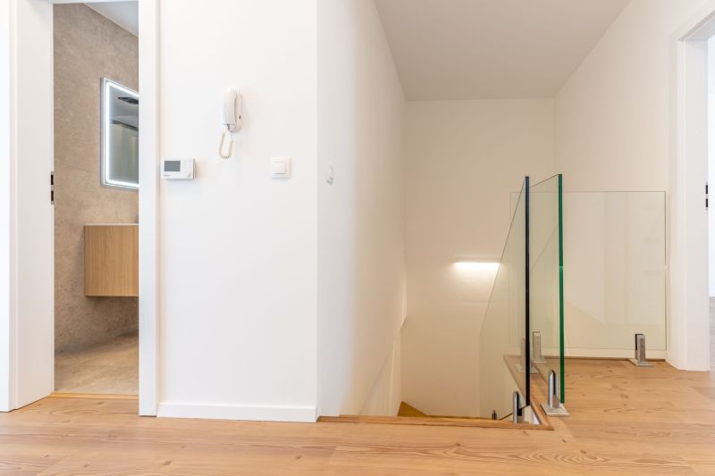 Family house with a hallway, staircase, wooden decor flooring, and a bathroom.