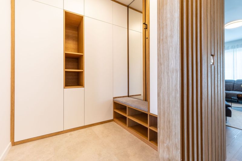 A hallway in a family house with furniture, seating, and wooden wall paneling.